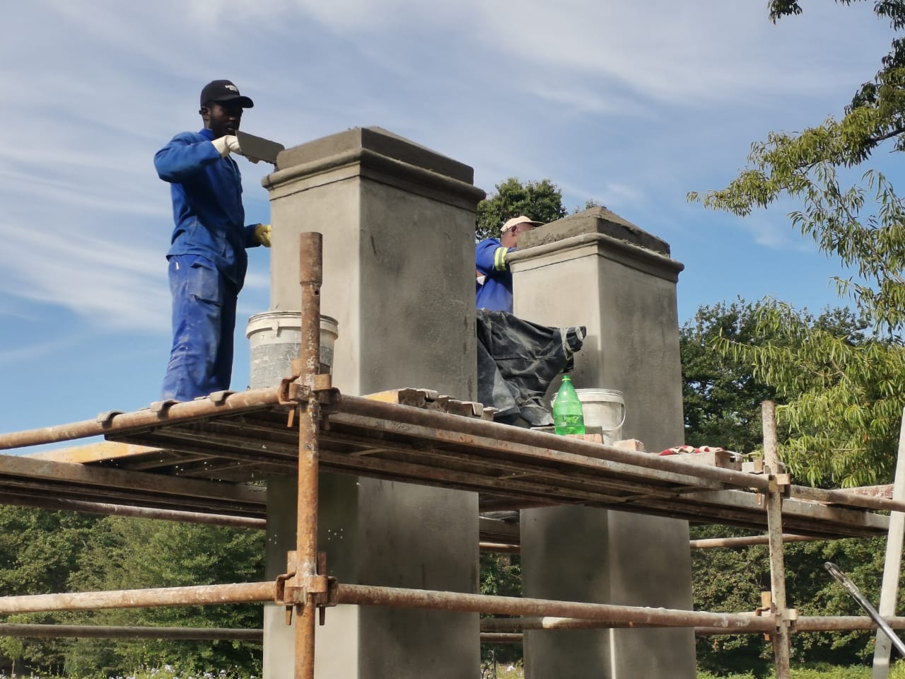 Brick support pillars under construction for a carport structure